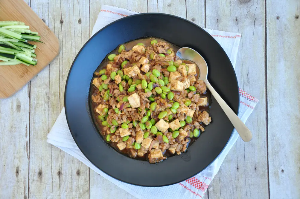 Hoisin noodles topped with a pan-fried sauce mixture featuring ground pork and edamame. It's quick, easy, and comforting.
