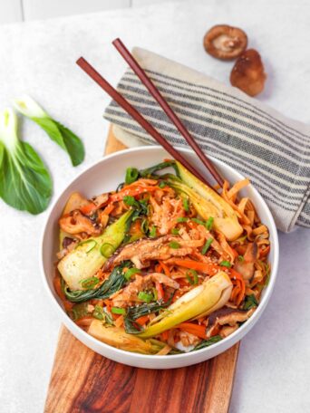 This quick and easy plant-based meal cooked in a delicious Korean stir-fry sauce features Asian mushrooms, carrots, bok choy, and rice noodles. Ready in 25 minutes.