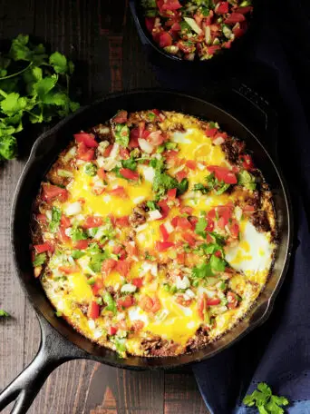 Baked eggs in barbacoa beef and topped with cheese, this is a perfect way to turn leftover barbacoa beef into an amazing brunch in just 20 minutes.