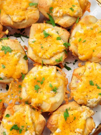 Cheese, crab, herbs and lemon, plus a pizza crust shaped into muffin cups, these cheesy crab appetizers are super fun and quick to make.