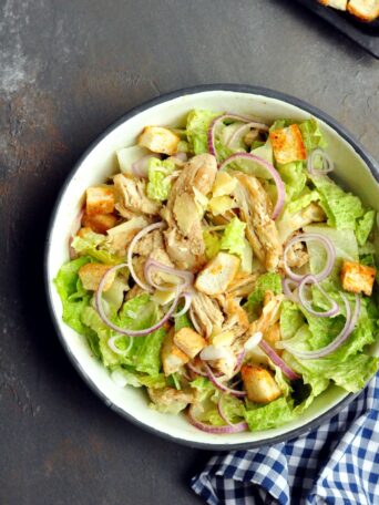 A delicious chicken salad recipe featuring the perfect shredded chicken, crunchy croutons, and a creamy tahini dressing.  