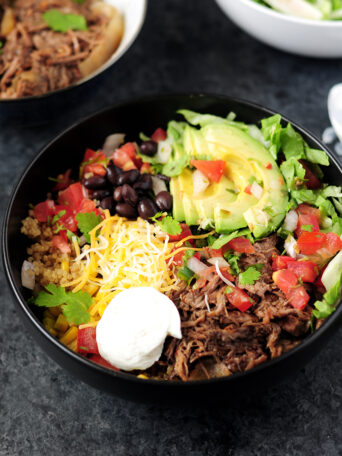 Recreate a healthy Chipotle burrito bowl in your own kitchen in just 15 minutes with slow cooker beef barbacoa and quinoa.