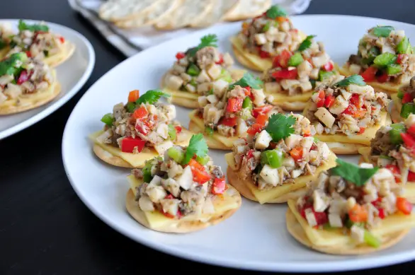 Easy cracker appetizers featuring king oyster mushrooms, tuna, bell peppers, and cheese of your choice. They are perfect for parties. 