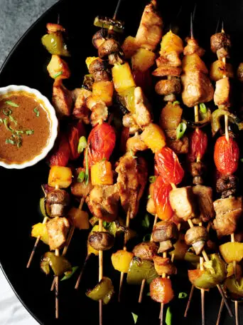 Chicken kabobs with marinated chicken, bell peppers, pineapple chunks, mushrooms and cherry tomatoes are packed with flavor and perfect for your gatherings.