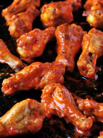 These buffalo-style grilled chicken wings take 20 minutes on the grill and they are finger lickin' good! You can also broil them in the oven.