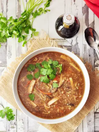 Authentic Chinese gluten-free hot and sour soup with loads of vegetables, tofu, and an egg cooked in a rich chicken broth or vegetable broth.