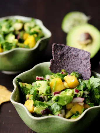 Refreshingly tasty mango avocado salsa that's a crowd-pleasing snack or appetizer with tortilla chips and it's amazing as a topping for seafood.