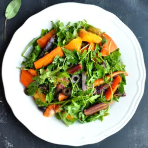 Boldly spiced sous vide carrot salad tossed with oranges and salty olives. It's a refreshing, satisfying, and stunning Moroccan-flavored dish with rainbow colors.