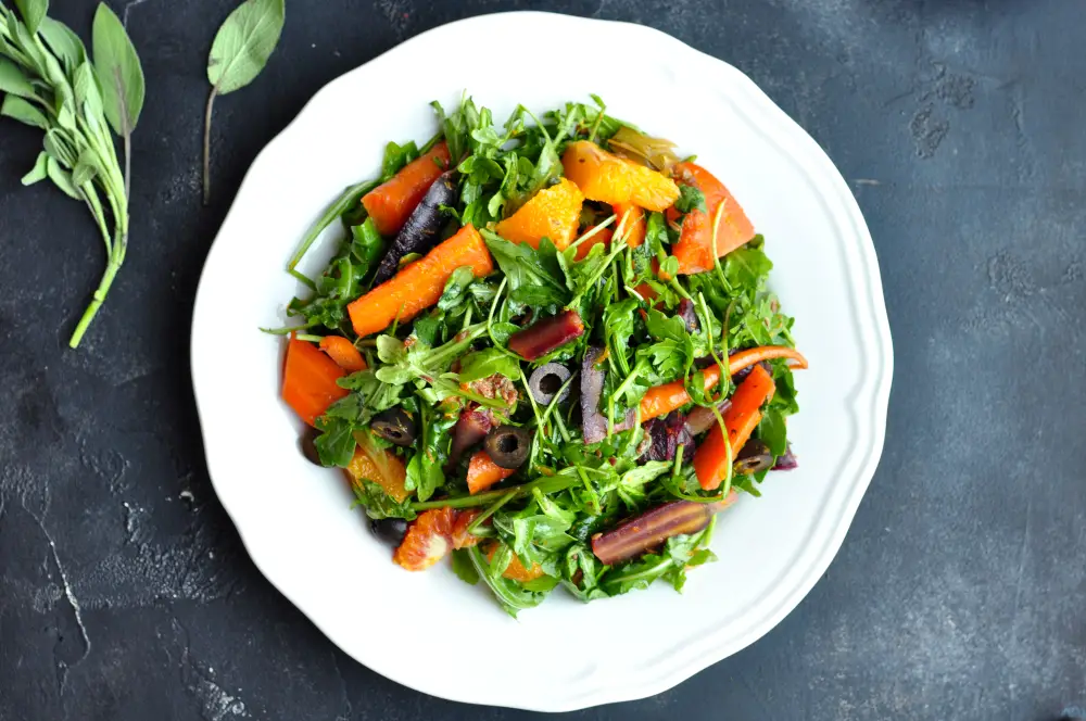 Boldly spiced sous vide carrot salad tossed with oranges and salty olives. It's a refreshing, satisfying, and stunning Moroccan-flavored dish with rainbow colors.