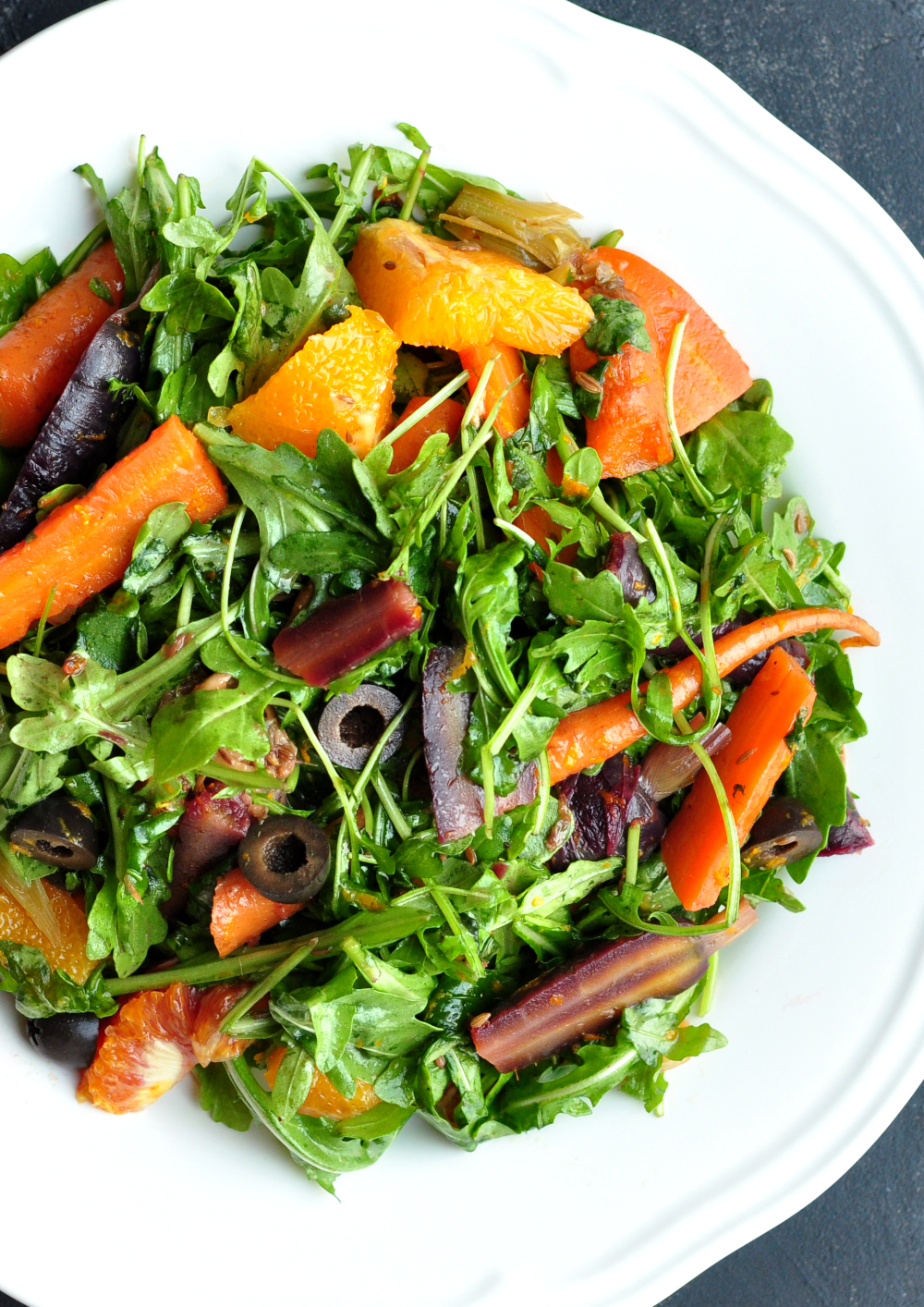 Boldly spiced sous vide carrot salad tossed with oranges and salty olives. It's a refreshing, satisfying, and stunning Moroccan-flavored dish with rainbow colors.