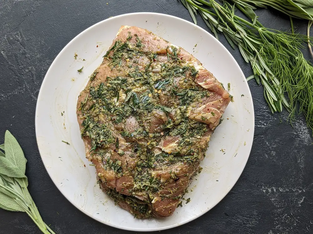 Rub the garlic-herb paste all over the pork loin roast evenly.