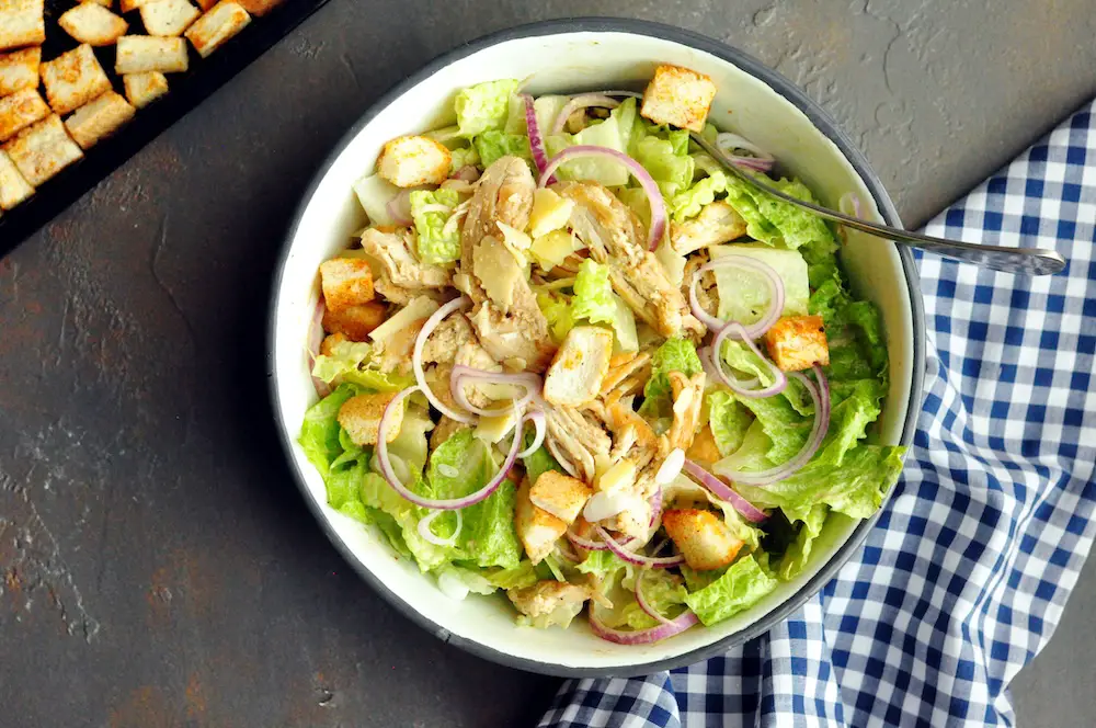 A delicious chicken salad recipe featuring the perfect shredded chicken, crunchy croutons, and a creamy tahini dressing.  