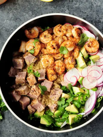 Colorful and delicious seafood quinoa salad made with nutritious chicken bone broth is the perfect light meal for a busy weeknight dinner.