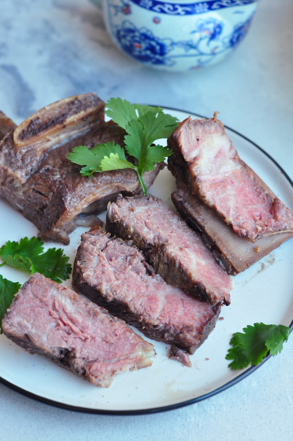 Sous vide beef short ribs slow-cooked in a gluten-free soy-coconut sauce with garlic, star anise, and bay leaves for a unique Asian flavor.