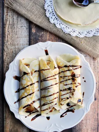 Simple crepes made from scratch and filled with peanut butter and banana then drizzled with chocolate syrup.