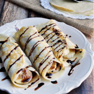 Simple crepes made from scratch and filled with peanut butter and banana then drizzled with chocolate syrup.