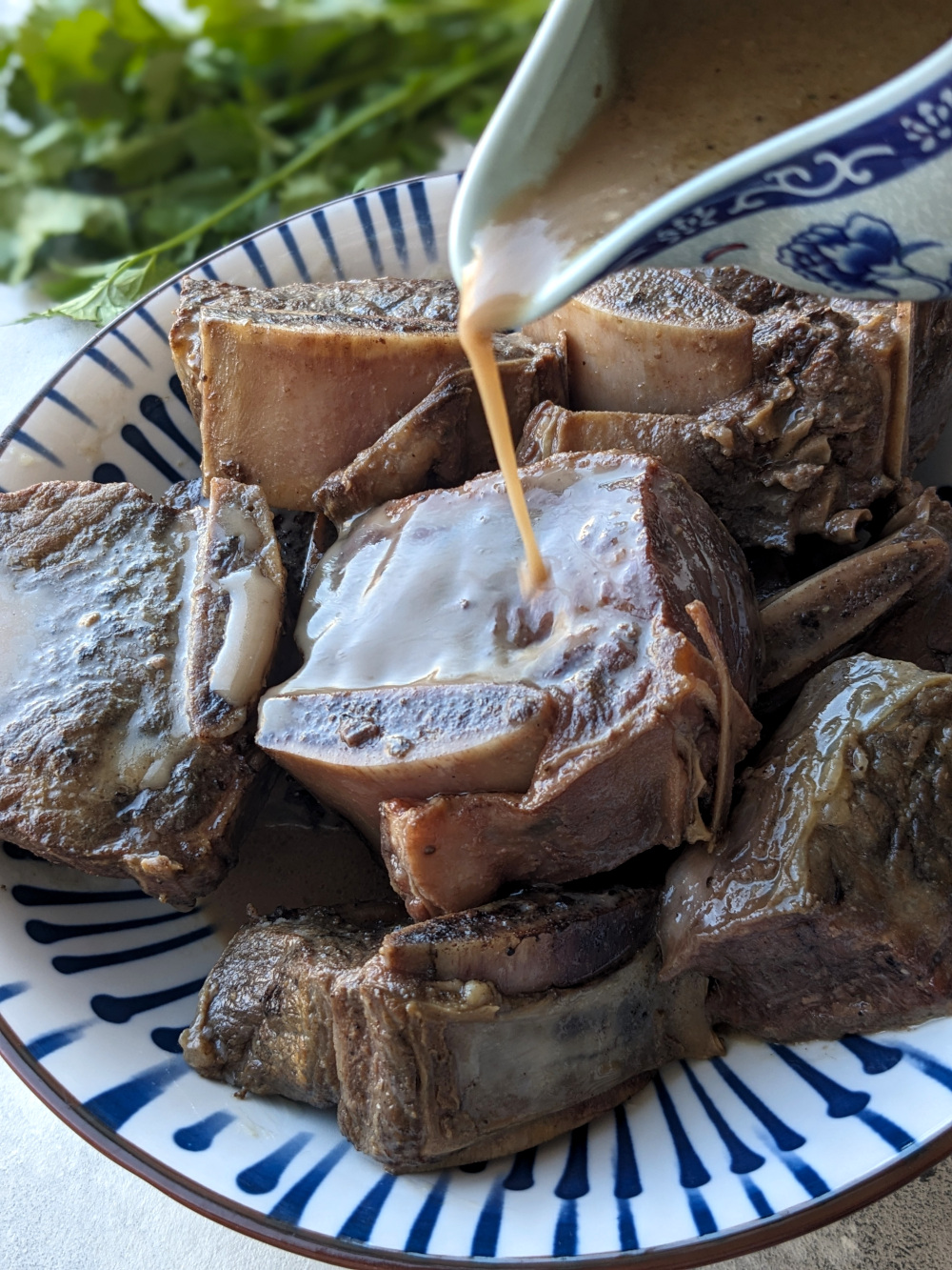 Sous vide beef short ribs slow-cooked in a gluten-free soy-coconut sauce with garlic, star anise, and bay leaves for a unique Asian flavor.