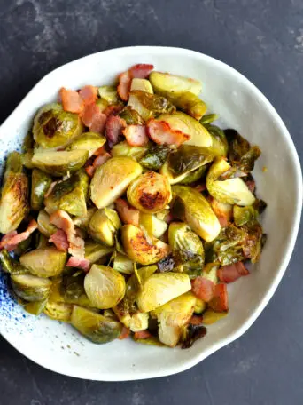 Sous vide Brussels sprouts cooked with bacon in garlic-infused bacon fat. It's a delicious match made in heaven.