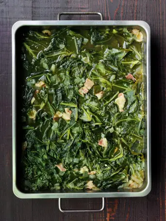 Easy and nutritious southern collard greens with bacon and bone broth slow cooked in the oven or on the stove. 