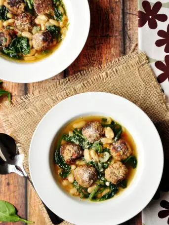 A simple twist on a classic Italian meatball soup: this hearty soup recipe features easy-to-make meatballs, vegetables, cannelloni beans, and spinach, simmered in a collagen-rich beef bone broth.