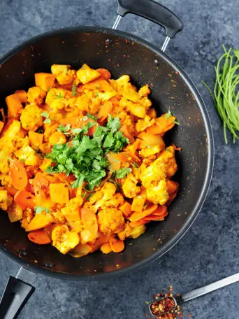 Thai red curry vegetables featuring cauliflower, sweet potatoes, carrots and onions cooked with white wine and simmered in coconut milk.