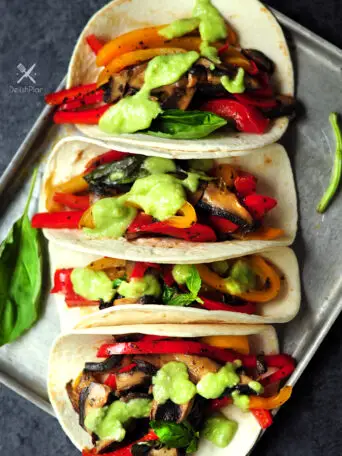 20-minute vegetarian tacos with bell peppers and portobello mushrooms cooked in a savory citrus sauce. It's a great meatless meal for your weekly meal plan.